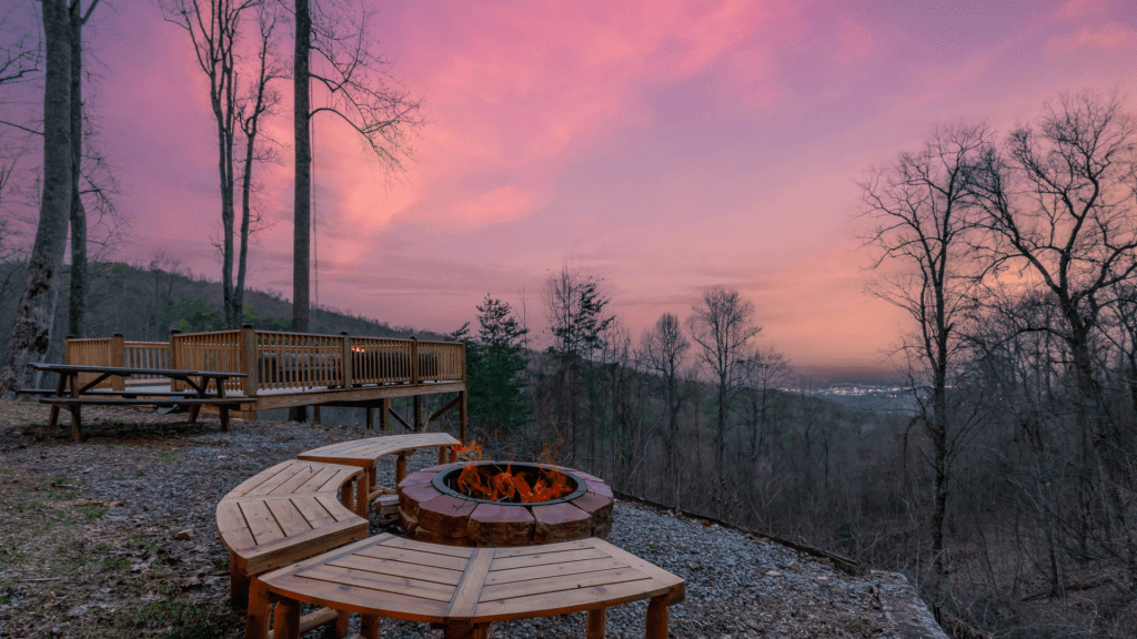 Fire pit area with wooden benches and Smoky Mountain views.