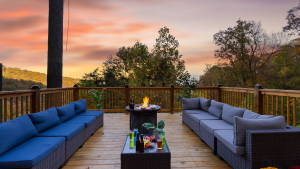 Outdoor deck with fire pit and views of the Smoky Mountains at sunset.