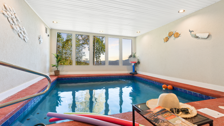 Private indoor pool with windows showing Smoky Mountain views.