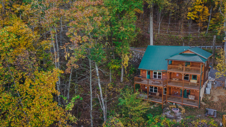 view of a private cabin surrounded by fall colors in the Smoky Mountains.