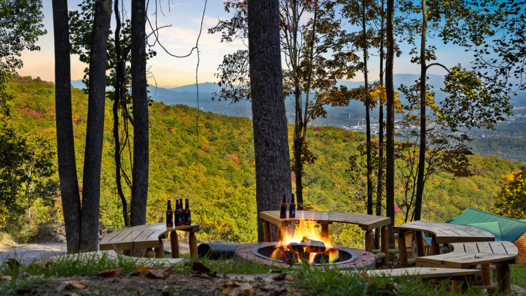 Outdoor fire pit with Smoky Mountain views and seating.