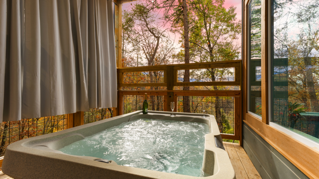 Private hot tub with champagne setup in a romantic Gatlinburg cabin for couples