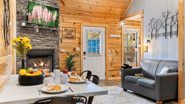 Cabin deck with chairs, a dining table, and mountain views