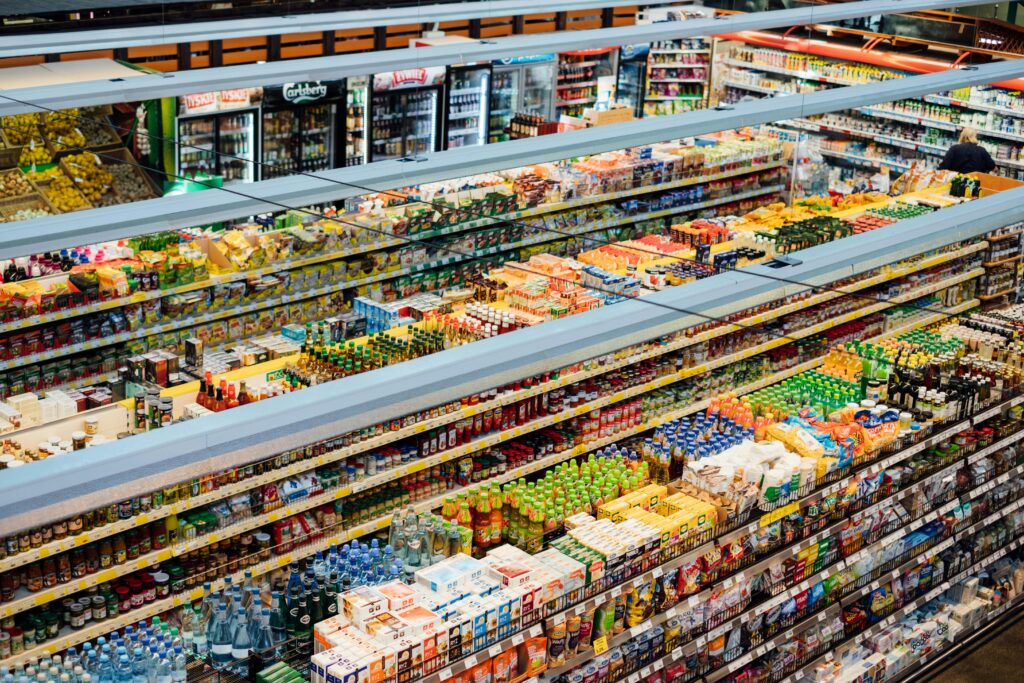 Aerial view of Gatlinburg grocery stores, with aisles filled with colorful packaged food and drink products, including beverages, snacks, and groceries, all neatly organized on shelves.